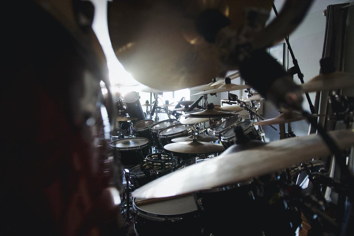 Image of a drummer miking a drum set